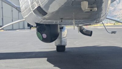 An image of a camera mounted beneath a Cessna 206 with RIS's total Airborne Law Enforcement Solution