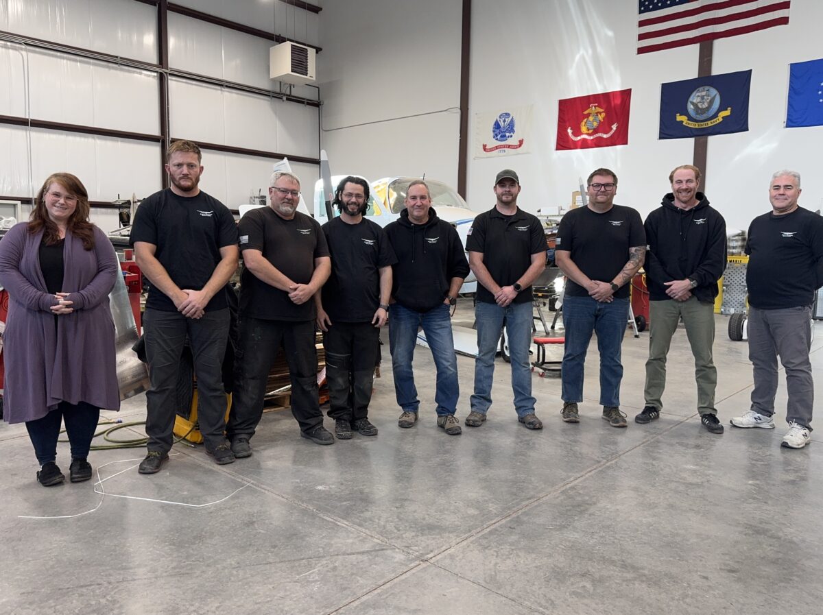 An image of RIS employees at the front of a hangar